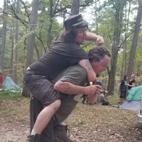 Two friends playing around at a campsite