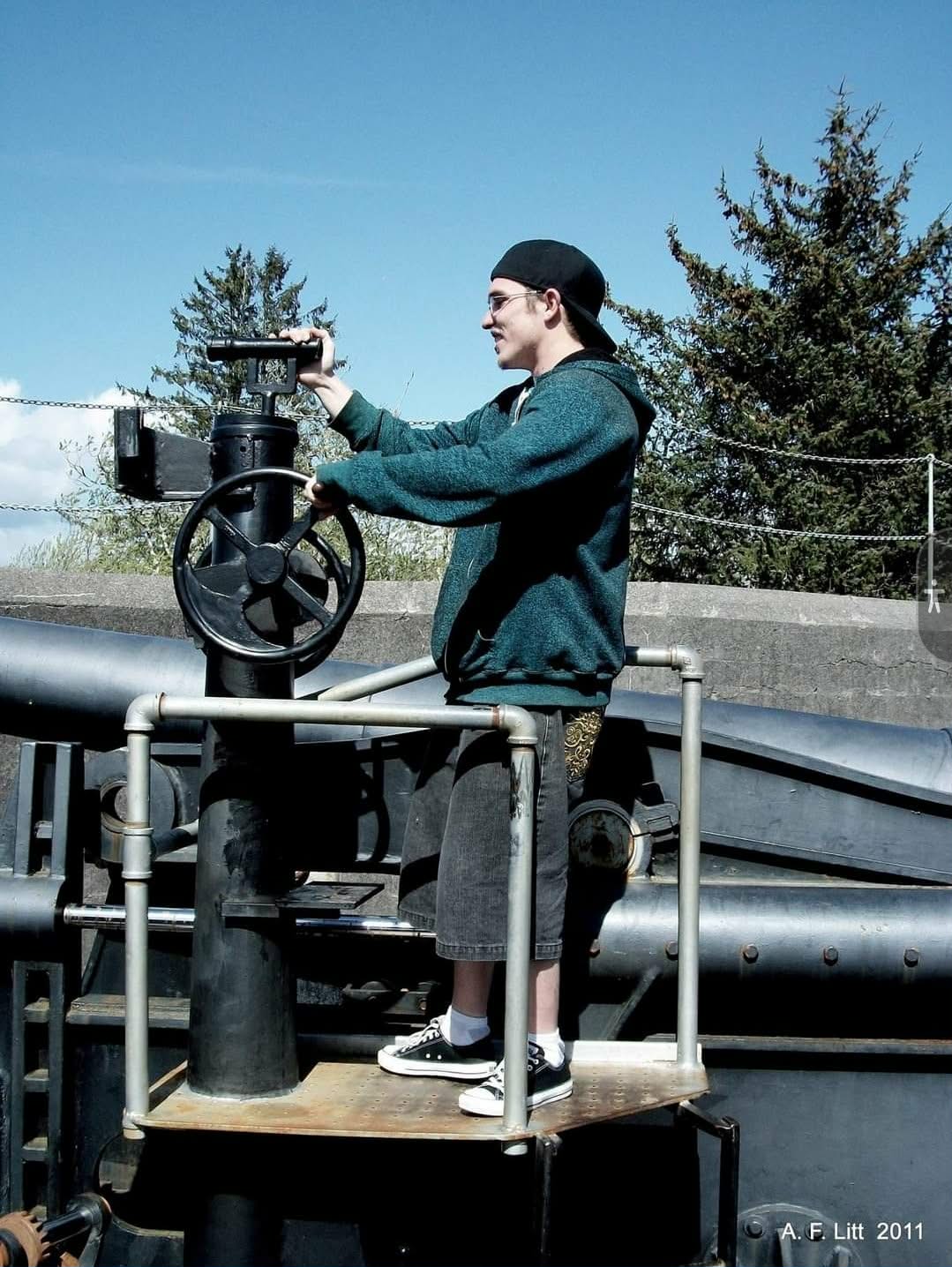 A loved one standing on a historic machine outdoors
