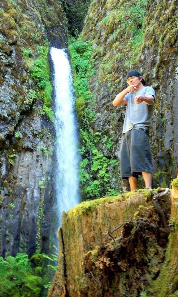 A loved one standing near a waterfall