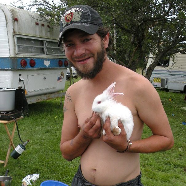 A loved one holding a white rabbit outdoors