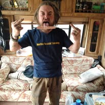 A loved one standing indoors making a playful face
