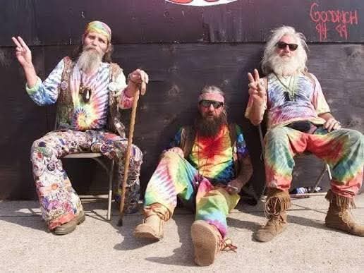 Three loved ones sitting together in colorful clothes